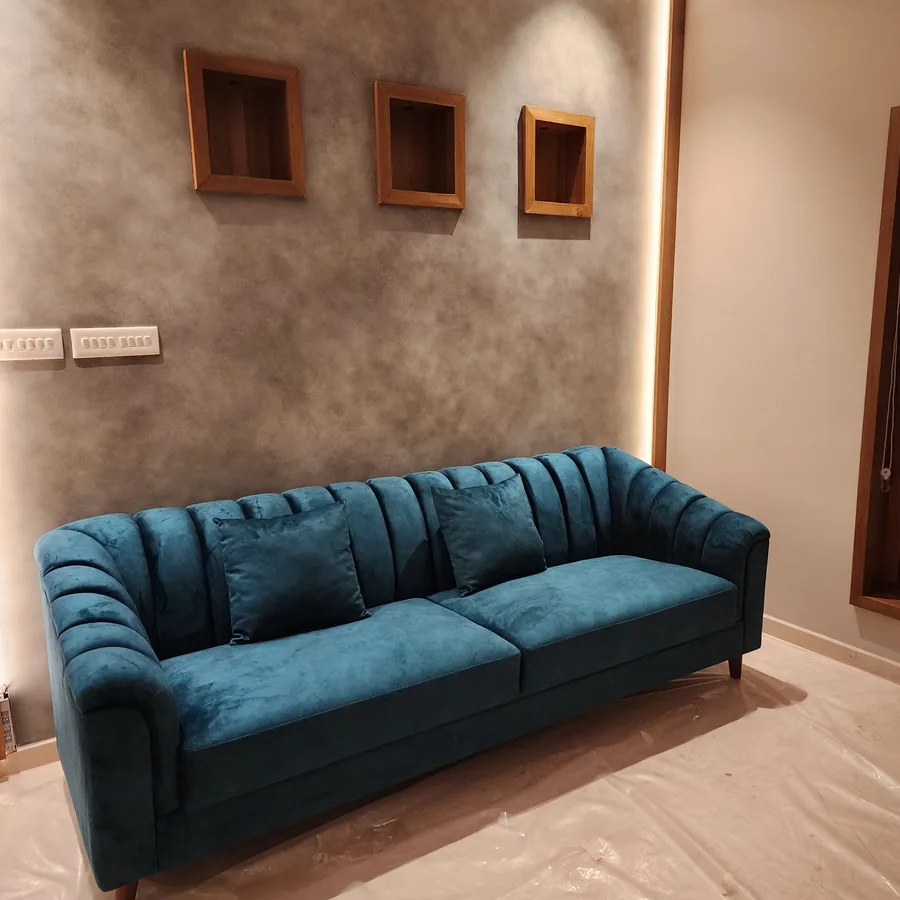 CRAFTOMAX teal sofa with wall finish in client home